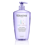 Kérastase Blond Absolu shampoo bottle on a green background 